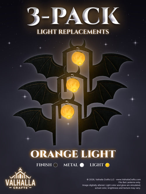 Bat Lantern Light Replacements 3-Pack, Black finish with Silver metal, Orange light: three bat-shaped replacement light inserts with spread wings, small horns, engraved wing lines and silver jump rings, overlapping one above another, each glass bulb glowing orange, on a dark misty night background with stars. Text reads 3-Pack Light Replacements, Orange Light.